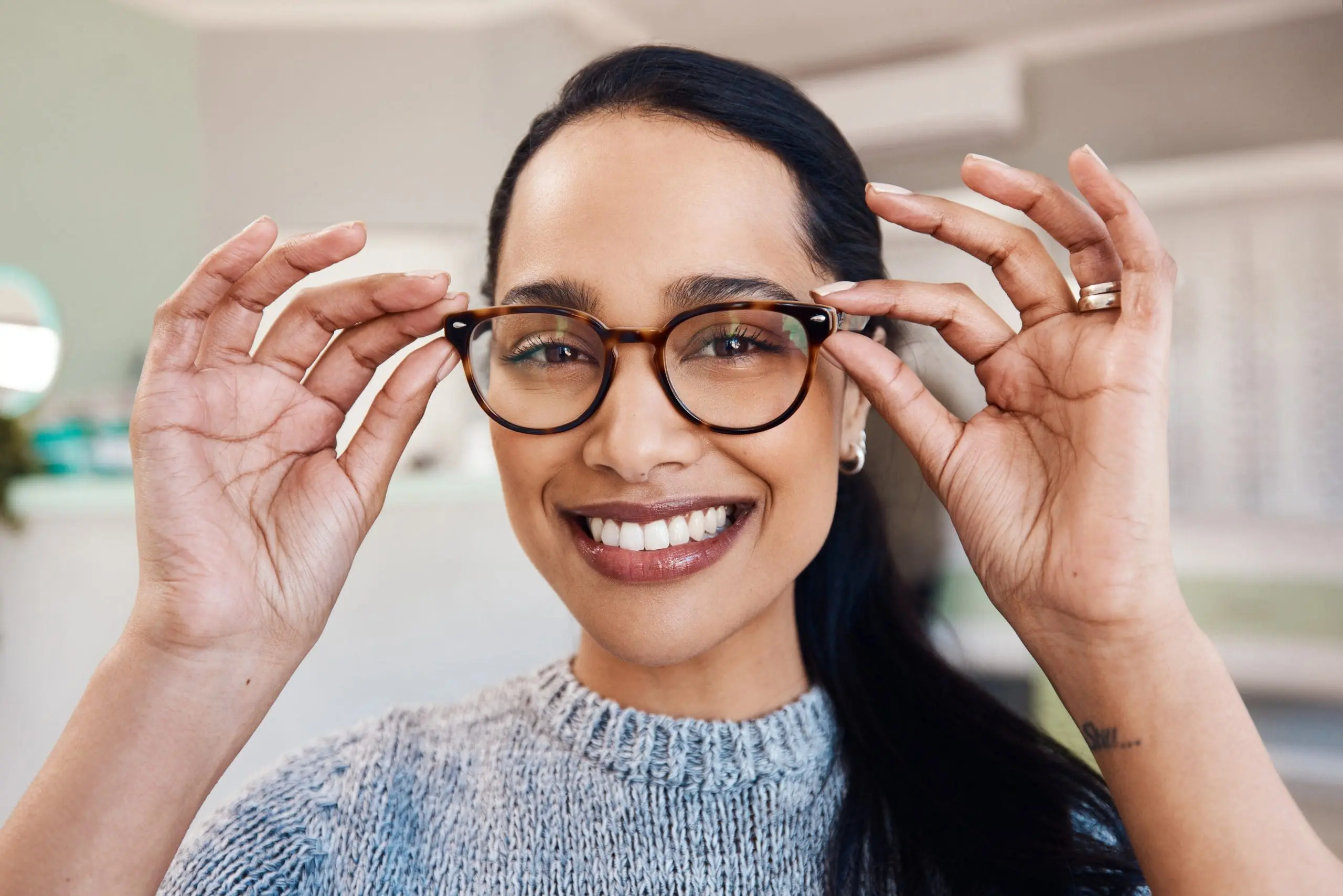Woman wearing glasses and happy. OptoDoc eyewear.